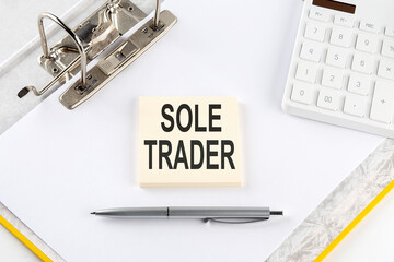 Poster - SOLE TRADER - business concept, message on the sticker on folder background with calculator