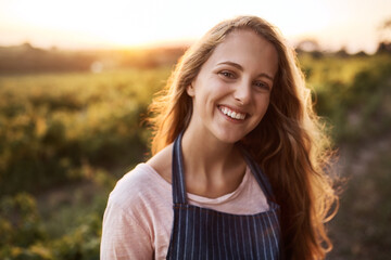 Farming is life. Portrait of a happy young woman working on a farm.