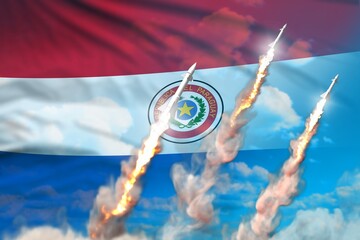 Modern strategic rocket forces concept on blue sky background, Paraguay ballistic warhead attack - military industrial 3D illustration, nuke with flag