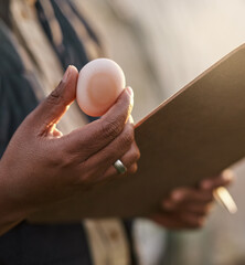 Poster - as fresh as eggs should be. shot of an unrecognisable farmer inspecting the quality of eggs on his f