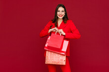 Attractive Woman In Red With Shopping Bags Sale On Red Background Saint Valentine's Day