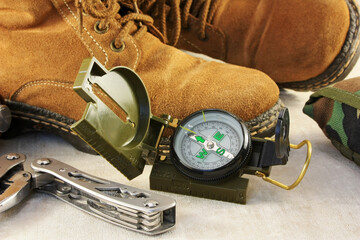 compass, multitool and old hiking boots