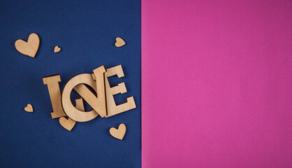 Wall Mural - Love word, small hearts on colorful paper background. Top view of Valentine's Day.