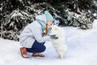 © len44ik - Happy teenage girl having fun playing with her dog on the snow in winter