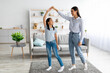 © Prostock-studio - Cheerful asian mother and daughter dancing to music, holding hands and enjoying spending time together at home