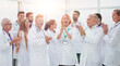 © ASDF - group of diverse smiling doctors applauding together.