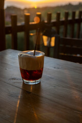 Wall Mural - Cup of Latte coffee on wooden coffee table.  Coffee break in the morning, relaxing and refreshing concepts. A white coffee cup on wooden table in the garden.