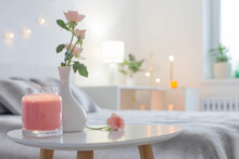 Pink Roses In Vase On Table In Bedroom