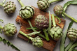 canvas print picture - Fresh green artichokes cooking on wooden background