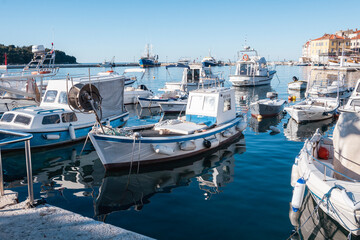 Sticker - Beautiful fishing boats anchored in the Rovinj city port, Istria, Croatia, during crystal clear winter morning, lit by gentle sun