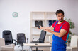 © Elnur - Young male repairman working at workshop