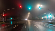 Traffic Lights On Empty Road In Foggy Night