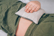 Boy using cherry pits heating pad. Cherry stone thermal pillows, cherry pit filled pillow - natural heat pack. Alternative medicine and therapy, pit sack for spa massage, chiropractic care