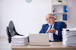 © Elnur - Old male employee and too much work in the office