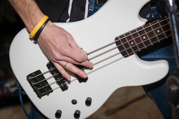 A man plays the guitar in close-up. Hands playing guitar close-up.