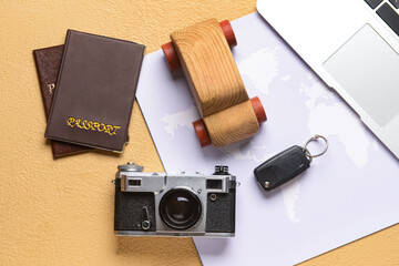 Poster - Wooden car with key, photo camera, passports and map on beige background