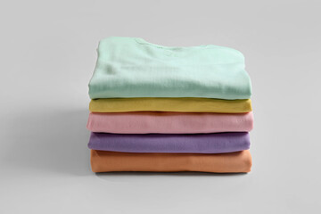 Stack of colorful clothes on white background