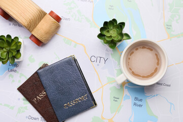 Wall Mural - Wooden car, cup with coffee, houseplants and passports on map