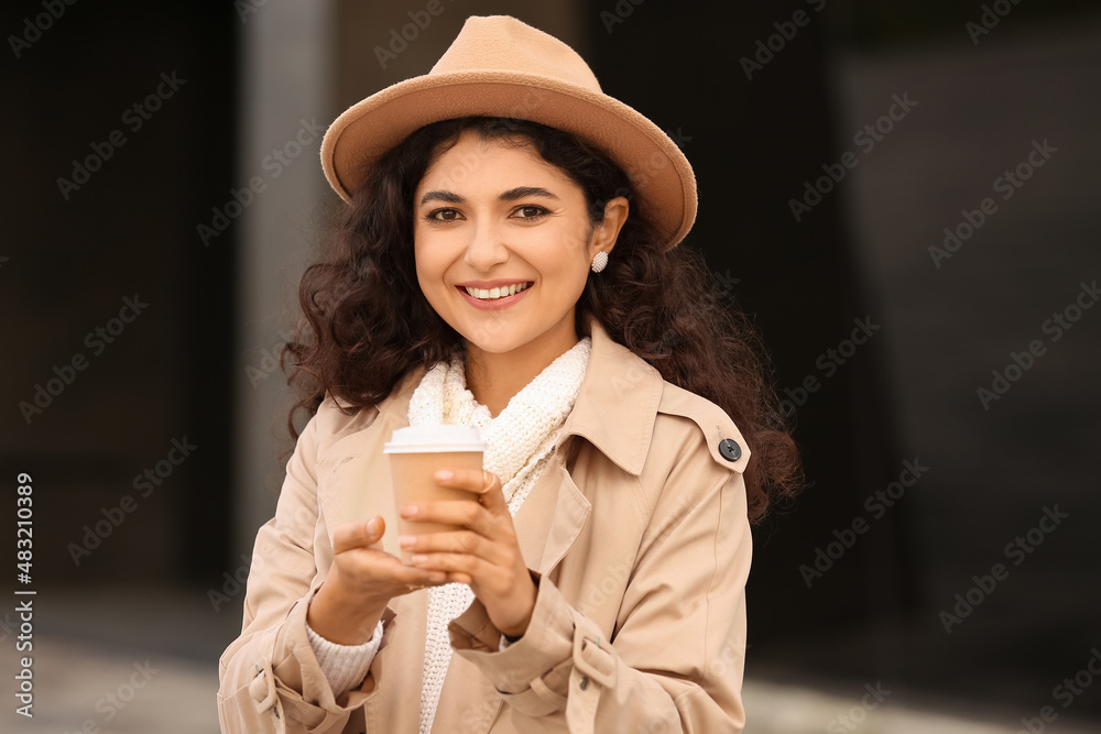 Beautiful woman drinking tea outdoors