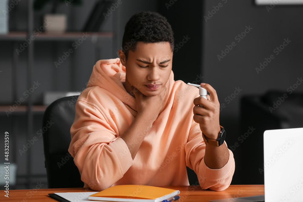 Ill African-American student with inhaler at home