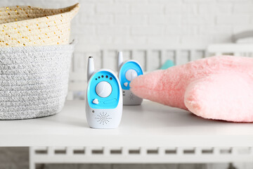 Modern baby monitor on shelf in light room, closeup