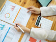 © bongkarn - Overhead shot of an office worktable with financial data report