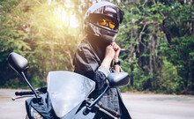 Confidence Asian Woman Wearing A Motorcycle Helmet Before Riding. Helmets Contribute To Motorcycle Safety By Protecting The Rider's Head.