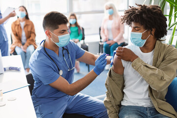Poster - Black Guy Receiving Vaccine Injection In Arm In Health Center