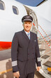 © Kostiantyn - Male aircraft pilot standing near airplane at airport