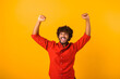 © Vadim Pastuh - Portrait of happy screaming handsome bearded man standing with excited face and rejoicing his victory. Indoor studio shot isolated on orange background