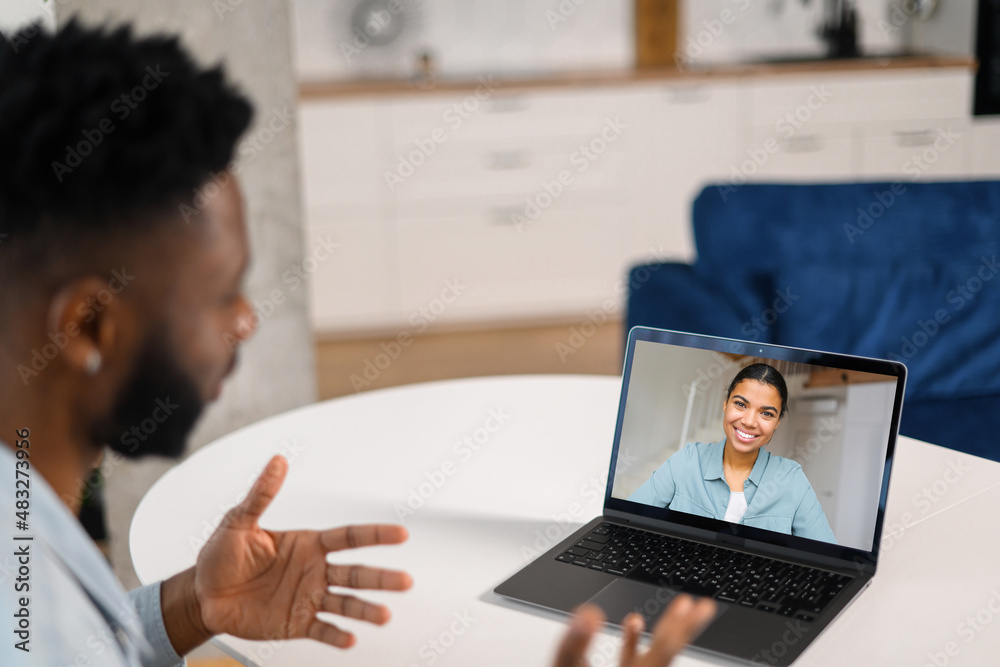 Back view of the african american guy talking with female friend or ...