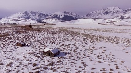 Wall Mural - Aerial footage of abandoned shacks in snowy Sierra Nevada, California