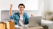 © tai - Surprised young man feeling shocked, excited cause hit their sales targets has ordered on their laptop computers and is ready to pack parcels to customers. Online shopping and online business ideas