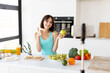 © Prostock-studio - Happy woman showing thumb up and holding apple, recording new video for sport and food blog, kitchen interior