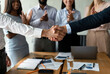 © Prostock-studio - Successful Deal. Closeup Shot Of Two Man Handshaking At Group Corporate Meeting