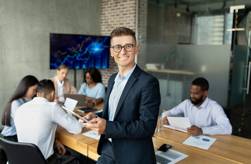 Poster - Business Leadership. Portrait Of Young Businessman With Digital Tablet Posing In Office