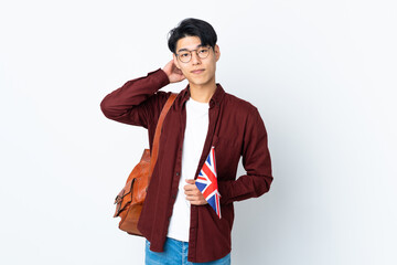 Wall Mural - Chinese man holding an UK flag isolated on purple background having doubts