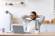 © Prostock-studio - Glad adult caucasian businessman with beard in glasses rest while working at laptop on minimalist kitchen interior