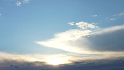 Wall Mural - beautiful sunset time. clear blue sky with sunny soft transparent white clouds on horizon line. 4k v