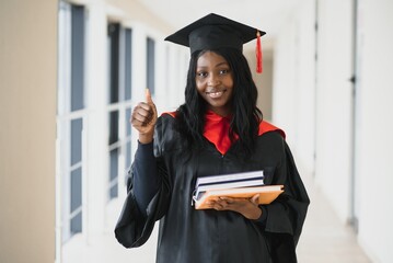 Wall Mural - beautiful young afro american graduate holding diploma