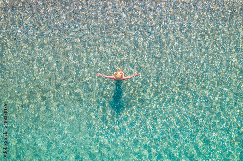 Top view. Young beautiful naked woman in a hat standing and sunbathe in