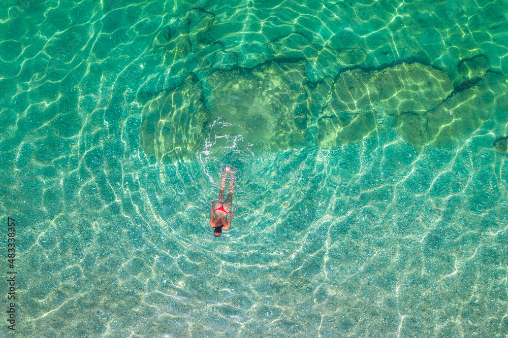 Top, aerial view. Young beautiful woman in a red bikini panties ...