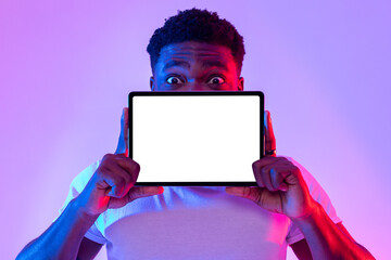 Poster - Tablet screen mockup. Cool black man covering face with blank touch pad, recommending new app or website in neon light