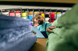 © Vergani Fotografia - black store seller checking inventory at fabric store