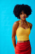 © Carlos David - young beautiful woman with afro hairstyle and summer outfit posing in studio