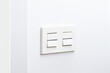White light switch and faceplate on white wall