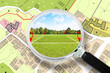 Searching a free Land plot with a vacant land available for building construction - Concept seen through a magnifying glass - note: the map is totally invented and does not represent any real place