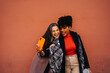 © ADDICTIVE STOCK - Happy multiracial women taking self portrait on mobile phone