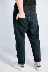 Wall Mural - Back pocket of black jeans. Man s hand in the back pocket of jeans. Copy, empty space for text