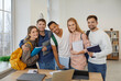 © Studio Romantic - Diverse team of five happy university students. Indoor group portrait of smiling mixed race multiethnic friends and interracial couples with books and backpacks standing together and looking at camera
